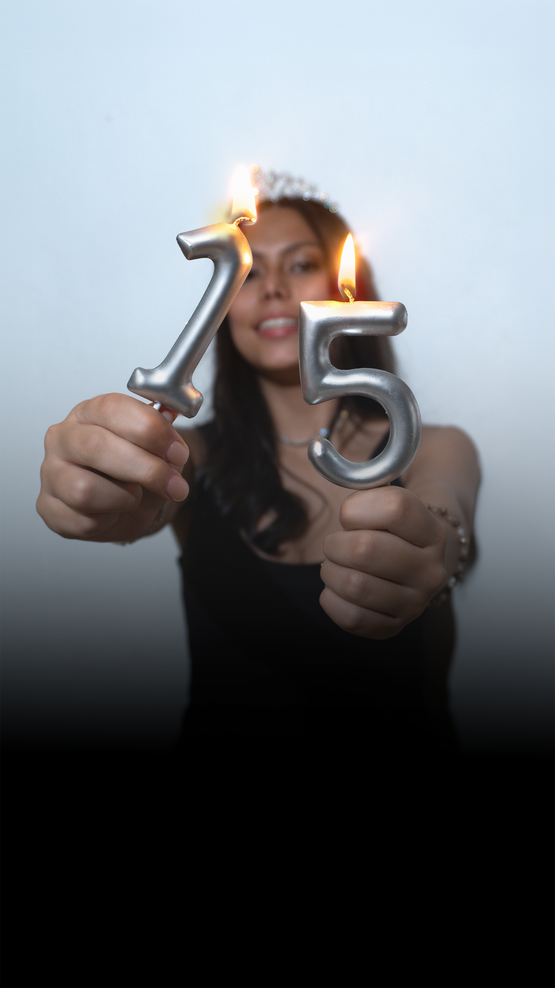 Nathalia sosteniendo velas con el número quince